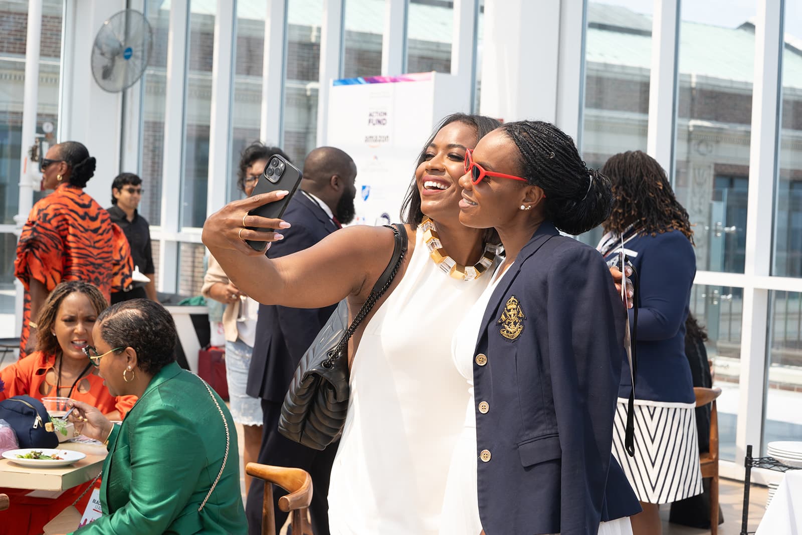 Two attendees taking a selfie at the Colored Girls Brunch event